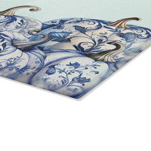 Load image into Gallery viewer, Chinoiserie Blue and White Pumpkins Glass Cutting Board on a kitchen counter
