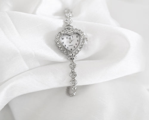 Heart-shaped rhinestone quartz watch with mother-of-pearl face, silver tone adjustable bracelet, vintage inspired design